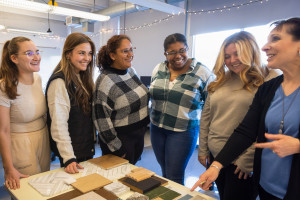 A group of students talking with Interior Design professor Fran Martini