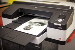 A printer with a black and white portrait printing.