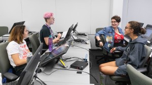 SADI 2019 students working and chatting in a computer lab.