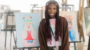 SADI 2025 student showing off their artwork