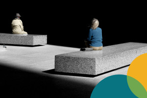 High contrast photo of man wearing a hat, a pigeon, and a woman sitting on stone benches from behind