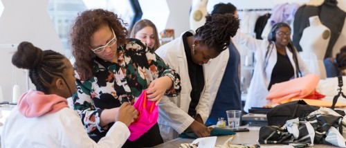 Fashion Design faculty and students working in the classroom.