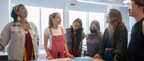 Art Education graduate students discussing their thesis projects
