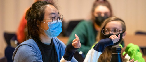 Masked student in discussions during class