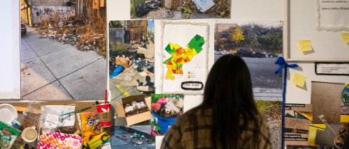 Graduate student viewing artwork in the MFA Exhibition 2022.