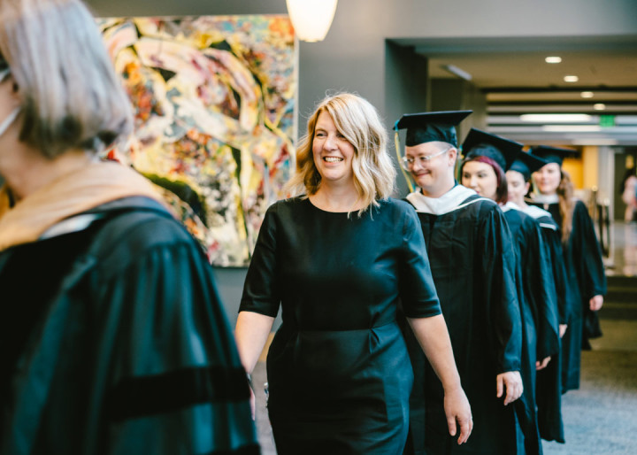 Art Education graduates and director Lauren Stichter walking at the Art Education 2021 Commencement