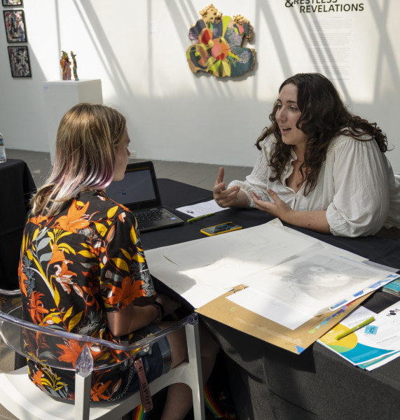 Admissions counselor Sierra Conniff reviewing a portfolio with a prospective student