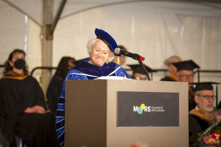 Photo of President Cecelia Fitzgibbon addressing the crowd from the podium. She is looking down and smiling.